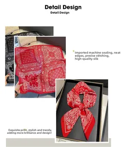 Détail d'un foulard carré à motif cachemire rouge avec des bords cousus avec précision
