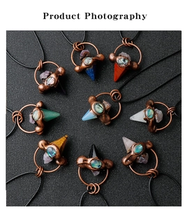 Macro shot of 9 vintage bronze hexagonal crystal pendants with abalone shell inlays