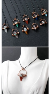 Close-up of hexagonal crystal pendant with abalone shell in antique copper setting