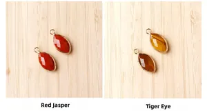 Detailed macro view of marquise-cut Red Jasper and Tiger Eye pendants with gold plating