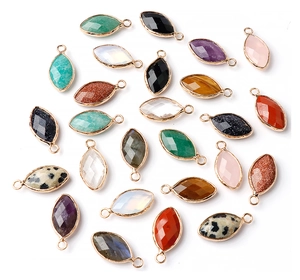 Macro view of multi-colored marquise faceted crystal pendants with gold metal edge