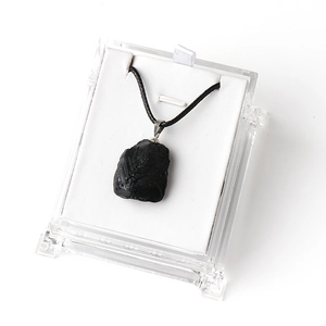 Natural raw black tourmaline pendant with irregular texture and black cord in a gift box
