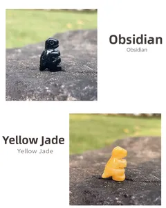 Detail of 1-inch hand-carved natural obsidian and yellow jade dinosaur gemstone figurines