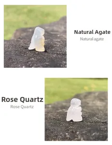 Detail of hand-carved natural rose quartz and agate squirrel stones on dark rock base