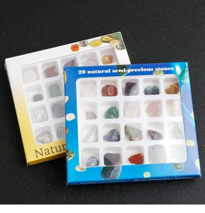 Macro view of 20 natural semi-precious stones kit in a white tray with colored paper box