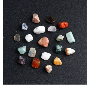 Detailed view of twenty colorful polished natural mineral stones on black sand background