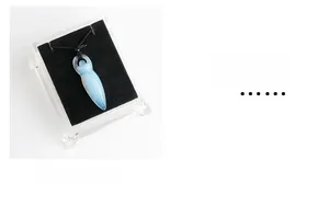 Detailed macro view of the semi-transparent opalite goddess pendant on a woven cord
