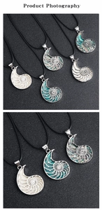 Detailed view of nautilus shell pendants in white, turquoise and abalone shell finishes
