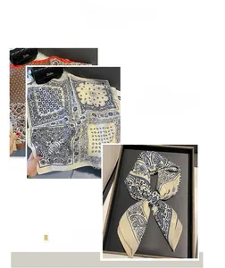 Détail d'un foulard carré à imprimé cachemire avec bordure scellée et texture soyeuse