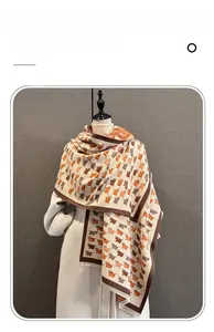 Detail of imitation cashmere scarf featuring cute cartoon cow patterns and soft fringes