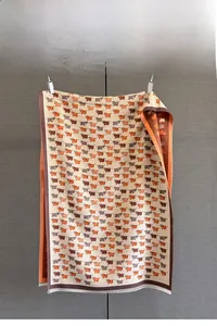 Detail of high-density jacquard scarf showing cute calf patterns and soft short fringes