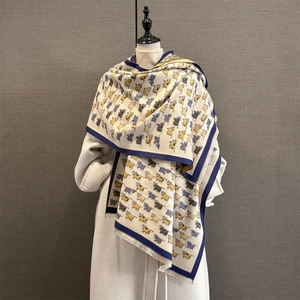 Thick warm scarf with cute cartoon calf patterns and fringe on a white wool coat