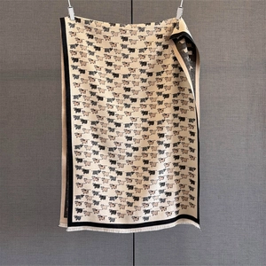 Detailed view of the soft knitted scarf with cute cartoon calf patterns and short fringe edges