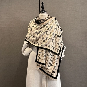 Close-up of soft beige calf pattern scarf with thick fringe detail on mannequin