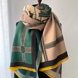 Detailed macro of thick patchwork scarf with equestrian pattern and fringe tassels