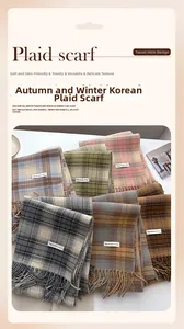 Detailed view of assorted vintage plaid scarves with elegant fringe in diverse colors