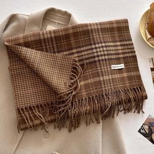Detail shot of vintage coffee plaid scarf with tassels and soft winter wool texture
