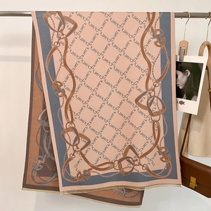 Detailed view of dusty pink scarf with equestrian chain patterns and fine fringe edges