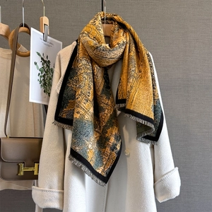 Artistic oil painting scarf in ginger yellow and dark green over a white wool coat