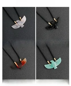Selection of carved crystal eagle pendants in rose quartz, obsidian, agate and aventurine