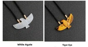 Detail of eagle pendants in white agate and tiger eye stones on braided cord
