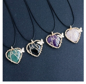 Detail of four wire-wrapped heart gemstone pendants with small butterfly charms