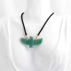 Natural green aventurine eagle pendant necklace on white mannequin with black cord