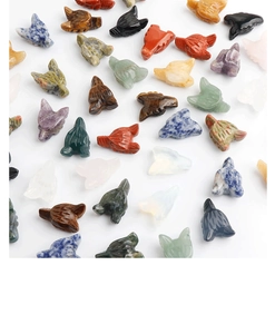 Detailed view of hand-carved natural gemstone wolf heads in quartz and amethyst stones