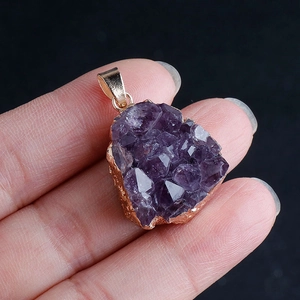 Natural amethyst crystal cluster teardrop pendant with gold edge on black background