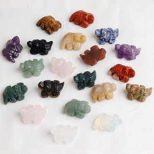 Variety of hand-carved natural gemstone crocodile figurines in amethyst and quartz stones