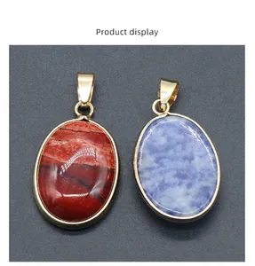 Detail of red jasper and blue sodalite oval stone pendants with gold plated clasps