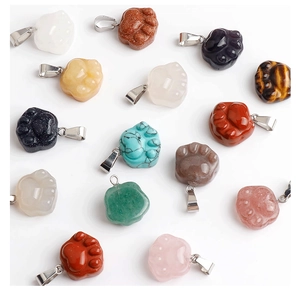 Macro view of assorted natural stone cat paw pendants with polished crystal and tiger eye textures