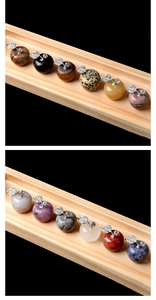 Detailed view of various natural crystal apple carvings with sparkling rhinestone leaf stems