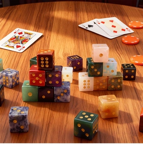 Detailed view of colorful gemstone gaming dice with gold numerals on a wooden table