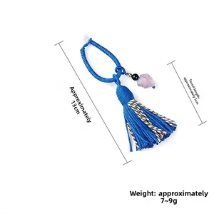 Ciondolo nappina blu intrecciata con cristallo viola e misure di 13cm di lunghezza