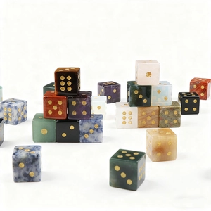 Close-up of assorted natural gemstone D6 dice with gold-filled dots and polished finish