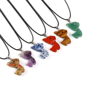 Detailed set of six fish-shaped natural stone pendants with black cords on white background