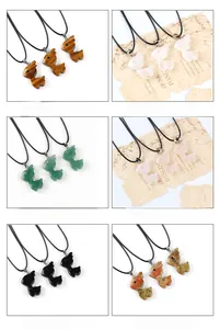 Selection of carved natural gemstone deer pendants including tiger eye and rose quartz