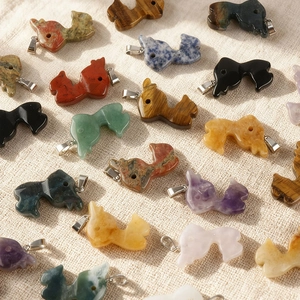 Detailed flat lay of various natural stone reindeer pendants with metal bails