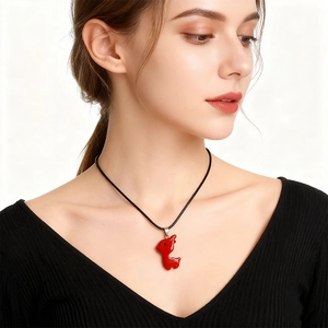 Red reindeer pendant necklace made of natural stone on a black cord for women
