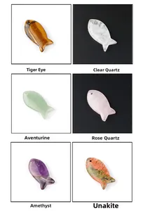 Detail view of fish-shaped natural stone pendants in tiger eye and amethyst varieties