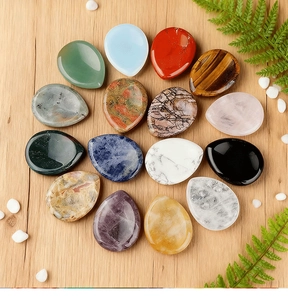 Detailed top view of 15 various heart-shaped natural gemstones on a rustic wooden background