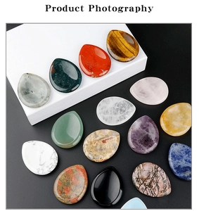 Macro shot of assorted water-drop shaped natural gemstone massage stones on display