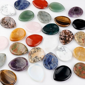 Variety of polished teardrop-shaped natural amethyst and tiger eye worry stones for massage