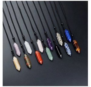 Macro shot of twelve hexagonal natural stone crystal pendants with black cord necklaces