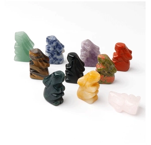 Detailed view of ten hand-carved rabbit figurines in diverse natural healing gemstones
