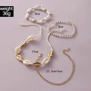 Detail view of 4-piece shell anklet set with woven rope and golden metal sea elements