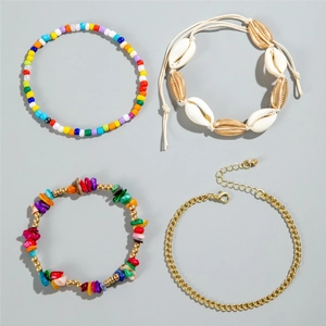 Detail of beach-style seashell woven anklets and colorful bead bracelet set for women