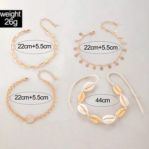 Detail view of four-piece Bohemian gold alloy anklet set with white shell charms