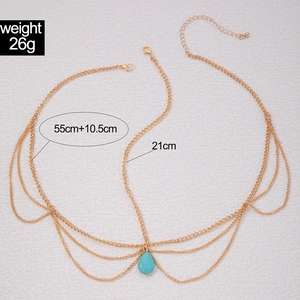 Detail of bohemian gold layered hair chain with turquoise pendant and size markings